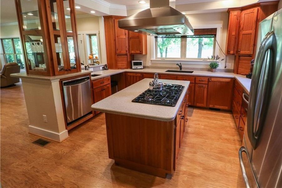 A kitchen with a wood floor

Description automatically generated